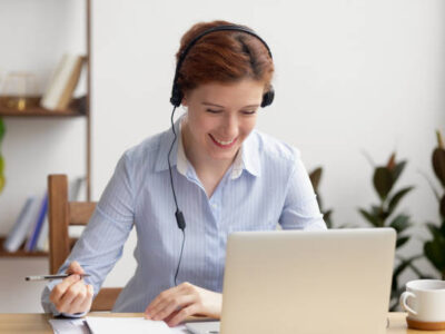 Happy Girl using Laptop and Headphone for NAATI CCL Class